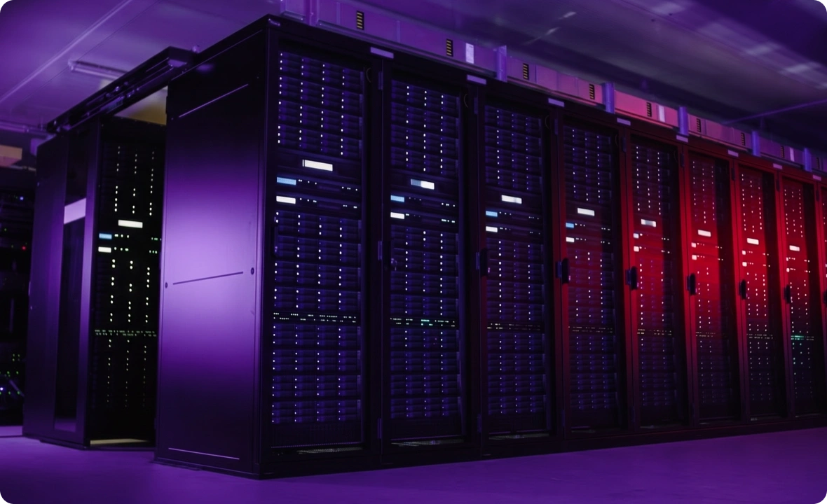 AI data sovereignty infrastructure: dark data centre with rows of illuminated server racks in purple and red light